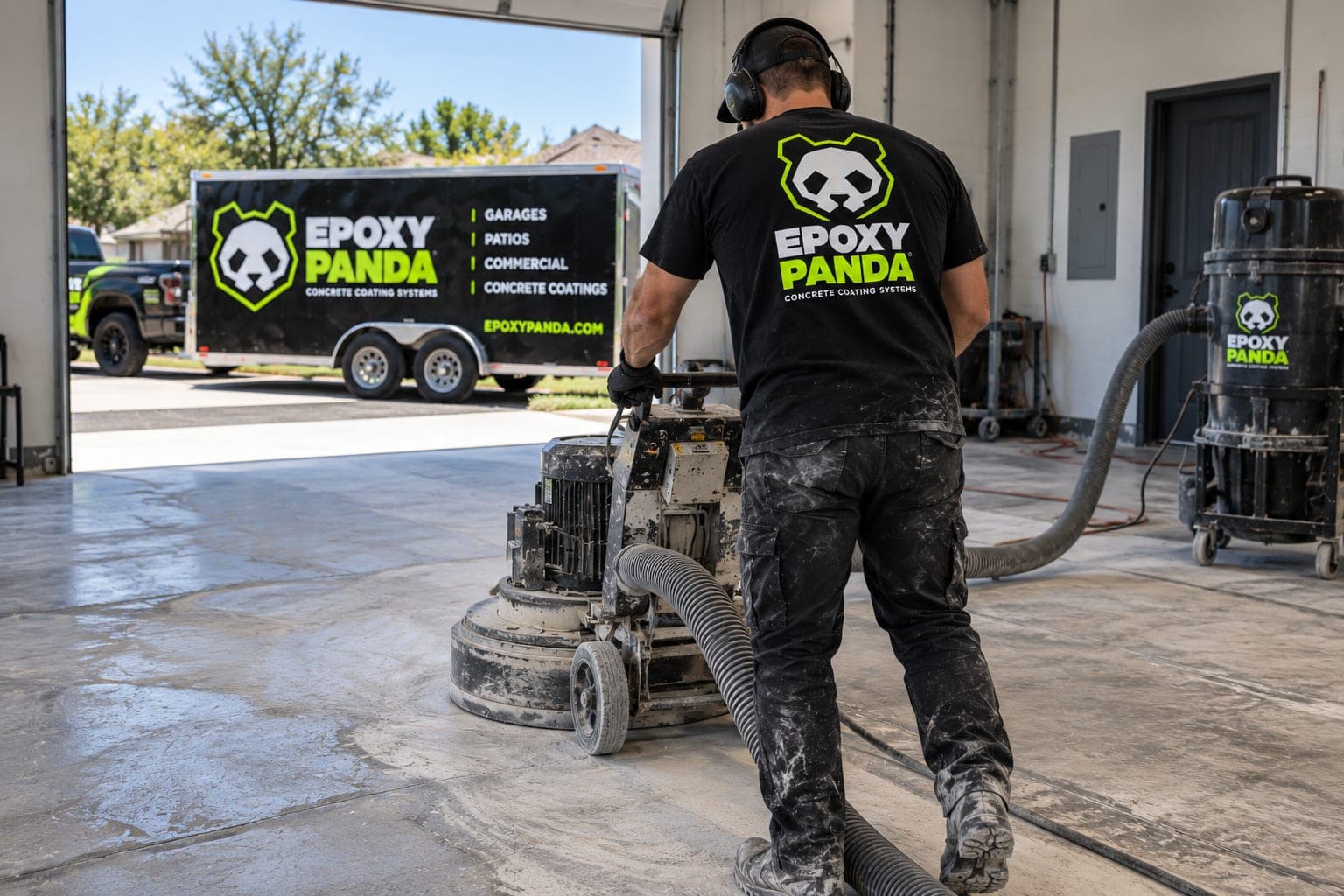Epoxy Panda crew member grinding a concrete floor with dust collection